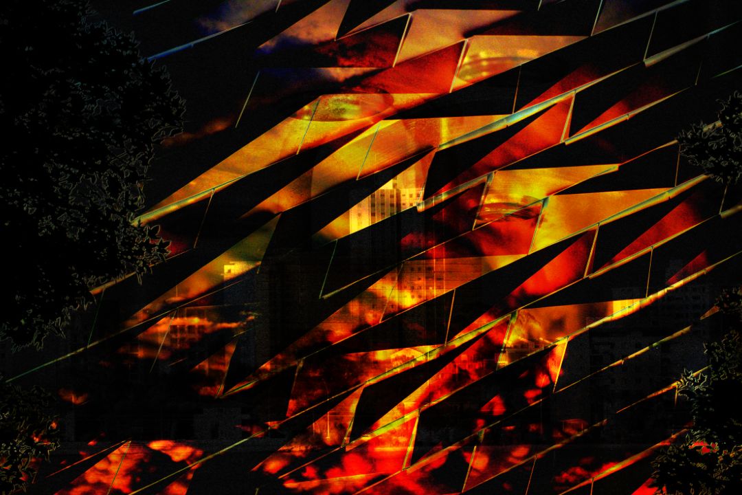 A lattice of angular orange shapes, in which a cityscape can be seen. Darkened leaves are visible around the edges of the image.